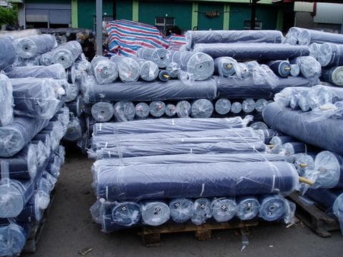 Rolls of denim fabric in the fabric store