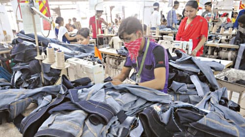 Stitching team at work on denim